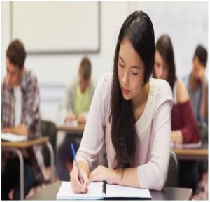 Student writing in classroom